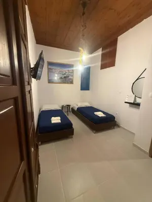 a room with two beds in a room at Occasus Room in Halki