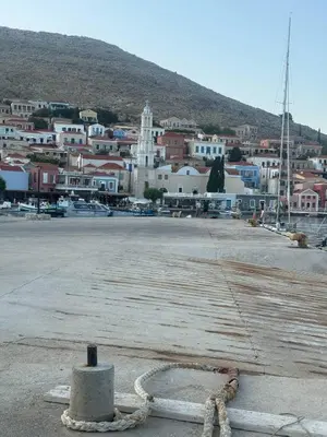 a large parking lot with a town in the background at Occasus Room in Halki