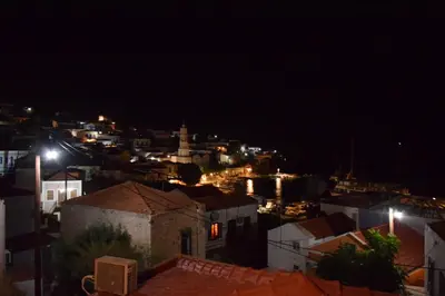 a view of a city at night at Occasus Room in Halki