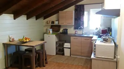 a small kitchen with a table and a counter top at Alexandra Homestay in Kalavárda