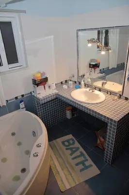 a bathroom with a tub and a toilet and a sink at Alexandra Homestay in Kalavárda