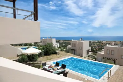 a view of a villa with a swimming pool at Athoniki Villas in Kalathos