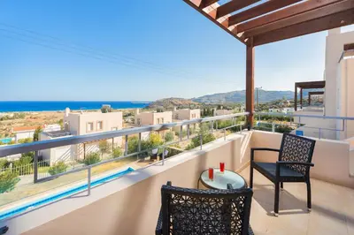 a balcony with a view of the ocean at Athoniki Villas in Kalathos