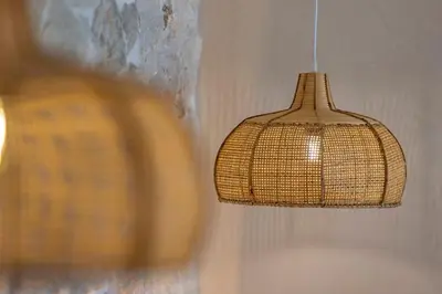 a wicker light fixture hanging from a wall at Milos Villas Complex in Pefki Rhodes