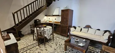 a living room with a couch and a table at Villa Aphrodite Lindos Suites in Líndos