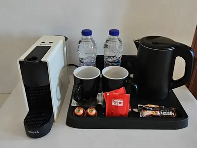 a tray with a coffee maker and two water bottles at Villa Aphrodite Lindos Suites in Líndos