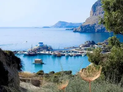 a group of boats docked in a body of water at Ktima Ellopia in Kolimbia