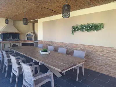 a large wooden table and chairs in a room at villa de calme in Pastida