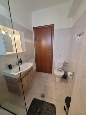 a bathroom with a toilet and a sink and a shower at villa de calme in Pastida