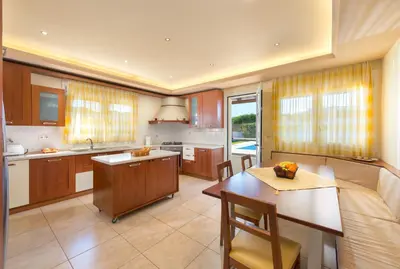 a kitchen with a table and a dining room at villa de calme in Pastida