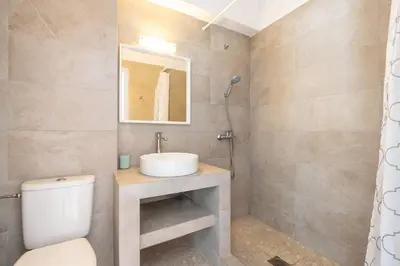 a bathroom with a sink and a toilet at Plakia Beach Apartments in Pefki Rhodes