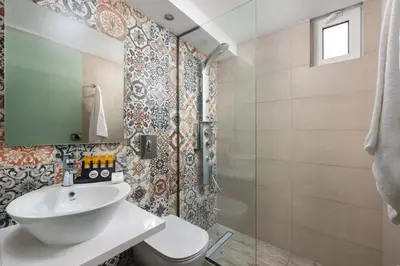 a bathroom with a sink and a shower at Lindos Citrin Studios in Líndos