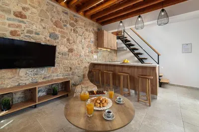 a living room with a table with food on it at Lindos Citrin Studios in Líndos