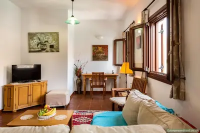 a living room with a couch and a tv at Perla di Mare in Symi