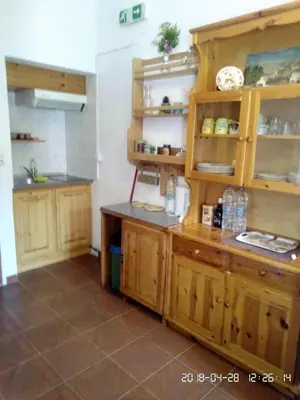 a kitchen with wooden cabinets and a counter at Perla di Mare in Symi