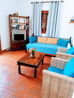 a living room with a blue couch and a coffee table at Perla di Mare in Symi