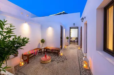 a living room with two benches and a window at Lindos Diamond Exclusive Villa in Líndos