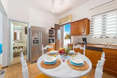 a kitchen with a table and chairs in a kitchen at Lindos Diamond Exclusive Villa in Líndos
