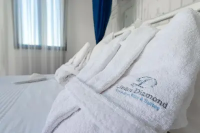 a pile of towels sitting on top of a bed at Lindos Diamond Exclusive Villa in Líndos