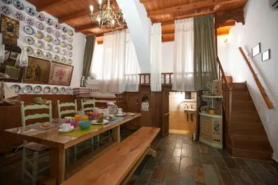 a dining room with a table and plates on the wall at Arch Villa in Phanaes