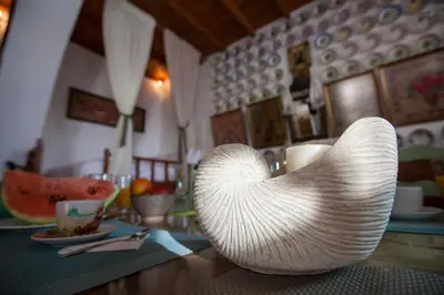 a white chair sitting on top of a table at Arch Villa in Phanaes
