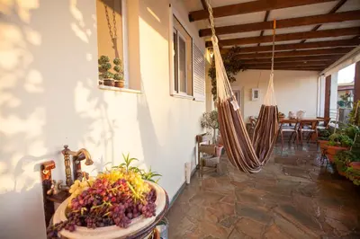a room with a porch with a hammock and a table at Arch Villa in Phanaes