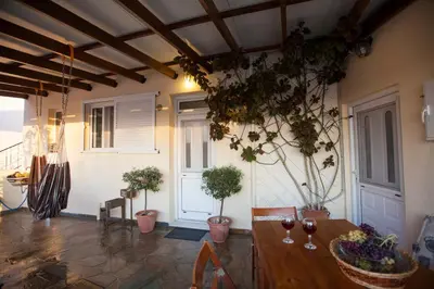 a room with a table with wine glasses and potted plants at Arch Villa in Phanaes