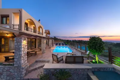 a villa with a swimming pool and a house at Butterfly Villa with stunning Sea and Valley Views in Theologos