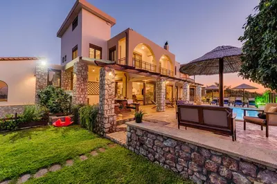 an exterior view of a house with a stone wall at Butterfly Villa with stunning Sea and Valley Views in Theologos