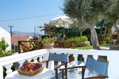 a basket of fruit sitting on a table on a balcony at Fotinis Cottage in Symi
