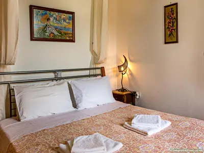a bedroom with a bed with two towels on it at Fotinis Cottage in Symi