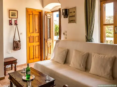 a living room with a couch and a table at Fotinis Cottage in Symi