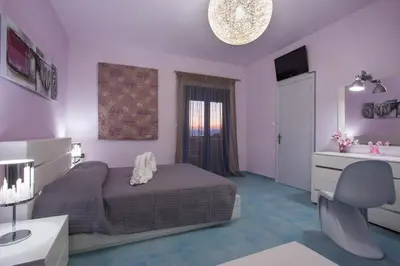 a bedroom with a bed and a bathroom with a sink at Villa Amor in Pefki Rhodes