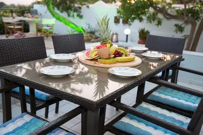 a table with a plate of fruit on it at Villa Amor in Pefki Rhodes