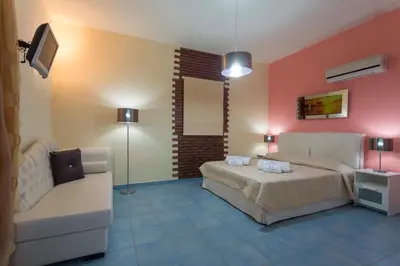 a bedroom with a bed and a couch at Villa Amor in Pefki Rhodes