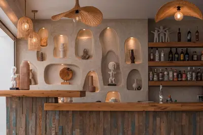 a bar with lots of different types of items on the wall at Lambis Studios & Apartments in Líndos