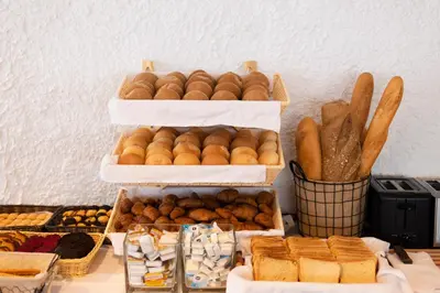 a display of different types of bread and pastries at Athena Hotel in Rhodes Town