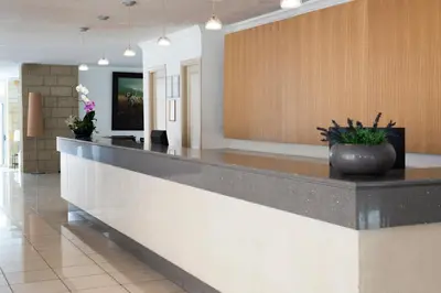 a lobby with a reception counter with a vase on it at Athena Hotel in Rhodes Town