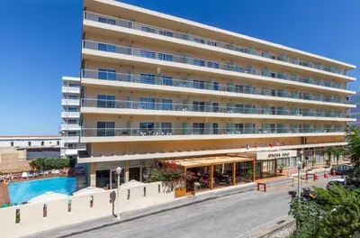 a large building with a pool in front of it at Athena Hotel in Rhodes Town