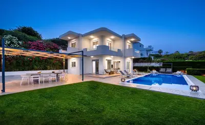 a villa with a swimming pool and a yard at Hill & Sea View Villas in Kolimbia