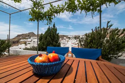 a basket of apples and pears on a wooden table at CasaLindos Spitaki in Líndos
