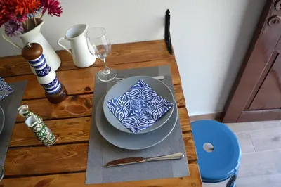 a table with a blue and white bowl and a glass at CasaLindos Spitaki in Líndos