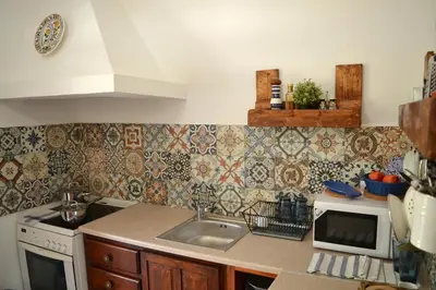 a kitchen with a sink and a microwave at CasaLindos Spitaki in Líndos