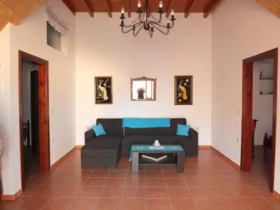a living room with a couch and a table at Casa Theoni in Kattavía