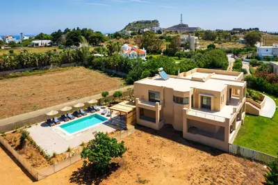 an aerial view of a house with a swimming pool at Villa Anolia with Private Pool in Koskinou