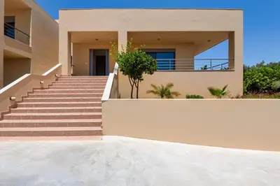 a house with stairs in front of it at Villa Anolia with Private Pool in Koskinou