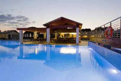 a large pool of blue water in front of a building at Island Blue Hotel in Pefki Rhodes