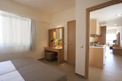 a bedroom with a bed and a kitchen in a room at Island Blue Hotel in Pefki Rhodes
