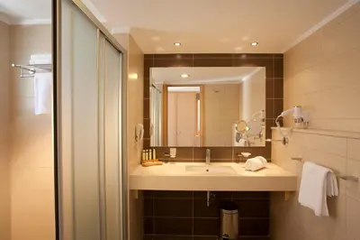 a bathroom with a sink and a mirror at Island Blue Hotel in Pefki Rhodes