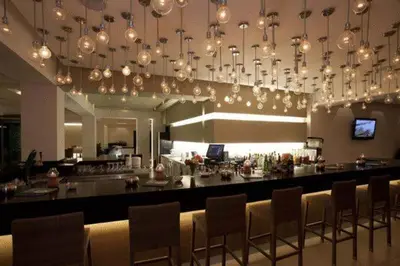 a bar in a restaurant with chairs and a counter at Island Blue Hotel in Pefki Rhodes
